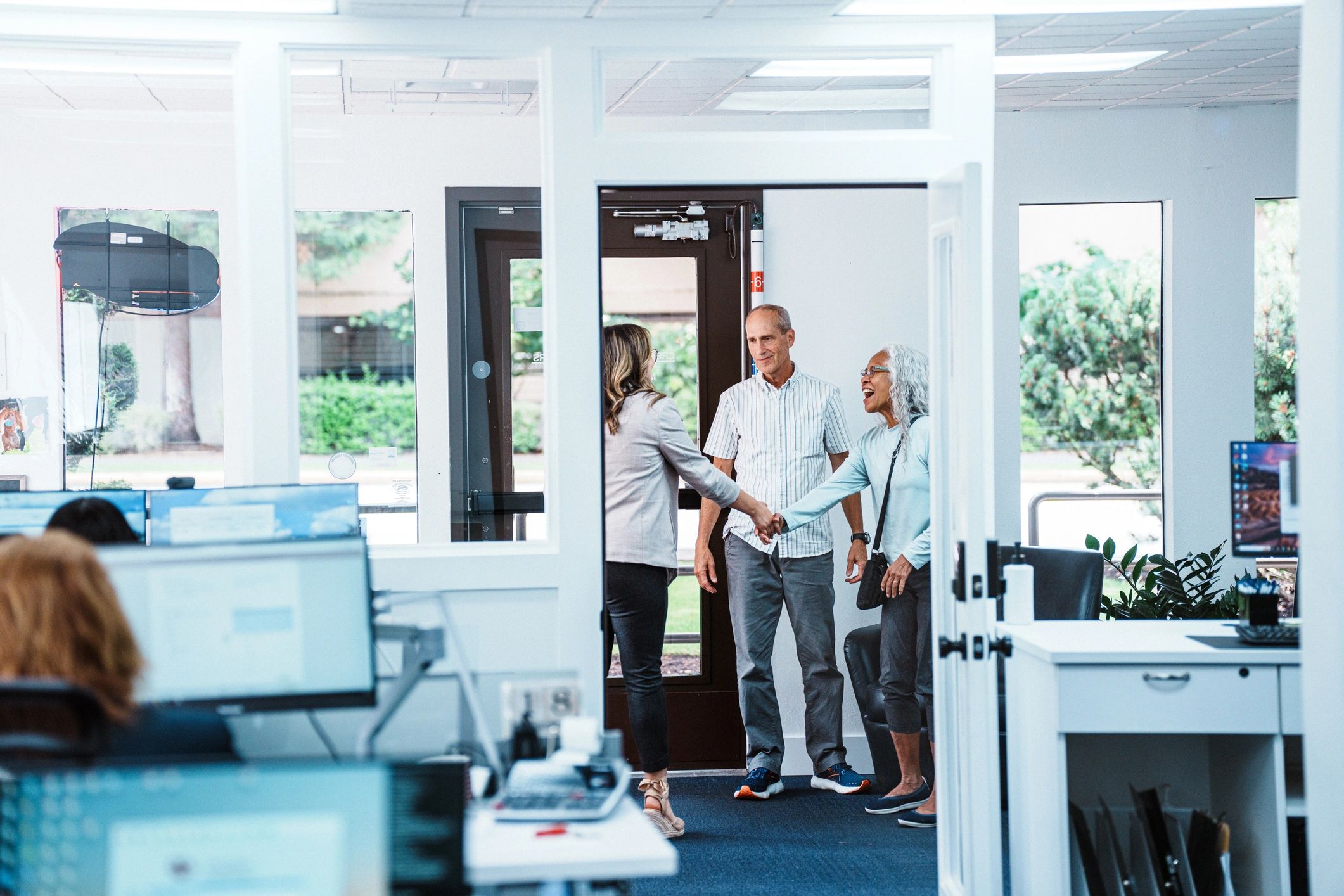 Financial services team assisting clients in a professional office